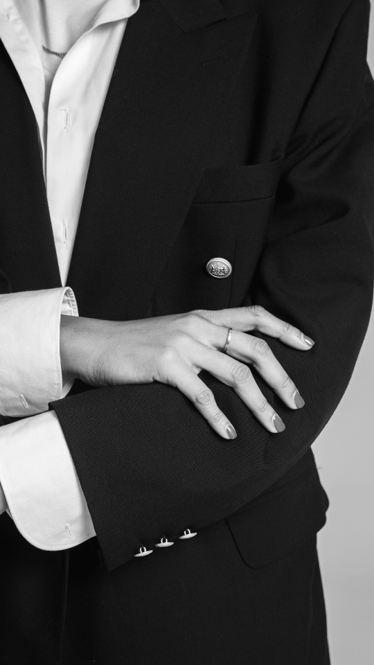 Faceless photo of a woman in a business blazer with her arms crossed